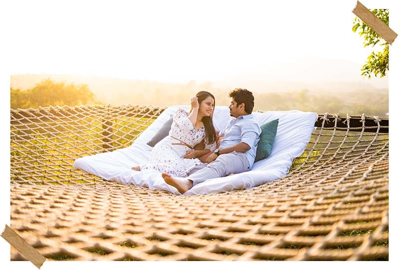 Mansi and Ashutosh relaxing on an outdoor daybed during their pre-wedding photoshoot, photographed by Bliss Memoir