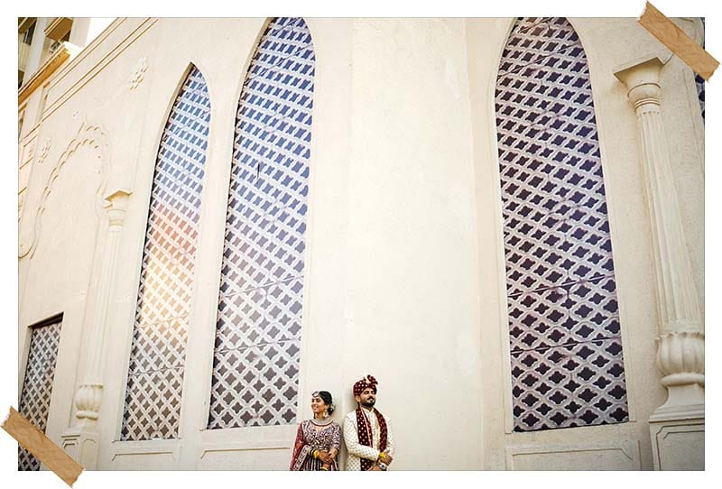 Ornate church archway and stained-glass windows at Revathi and Kevin's wedding venue, photographed by Bliss Memoir